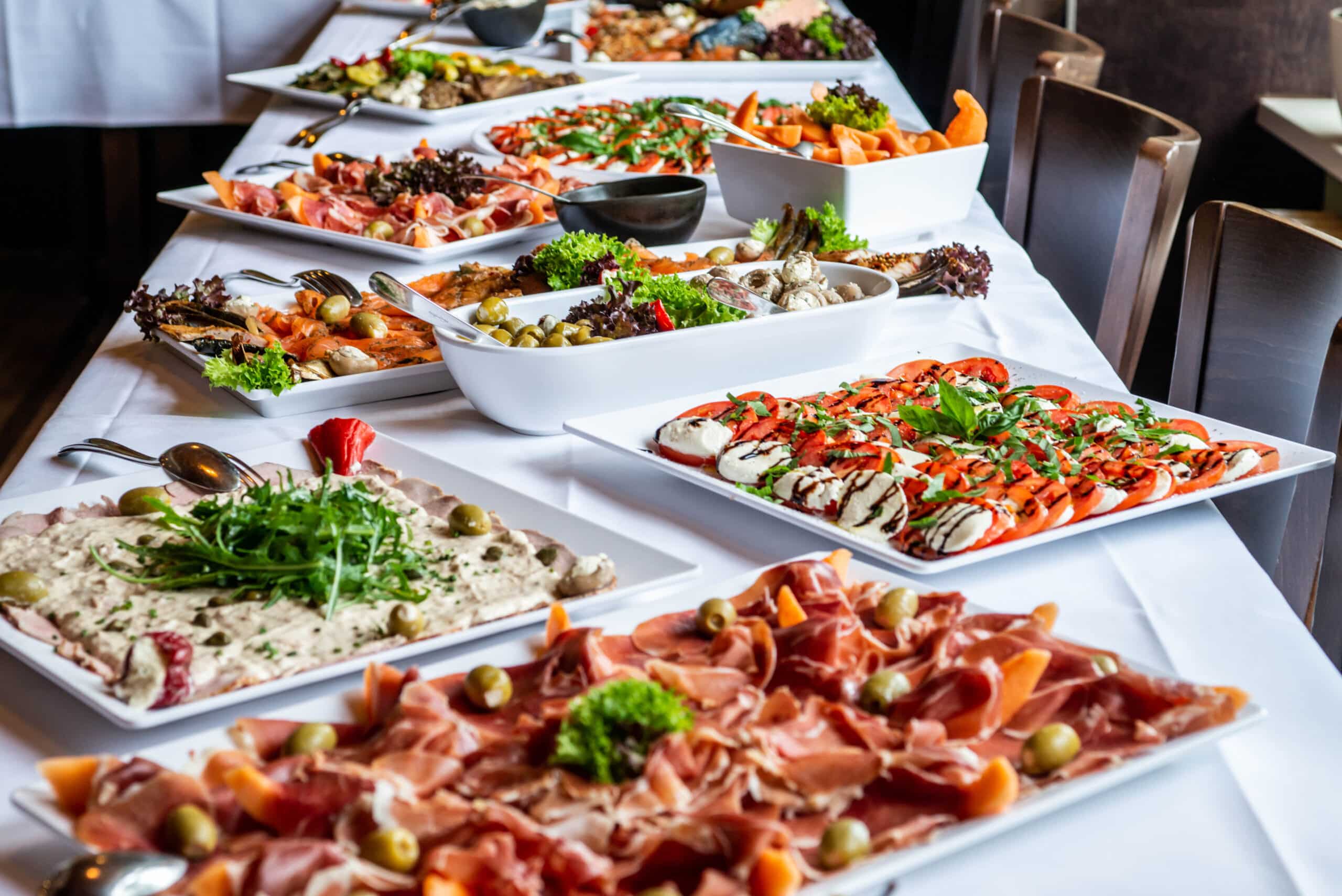 Party Brunch big Buffet table setting with Food Meat Vegetables