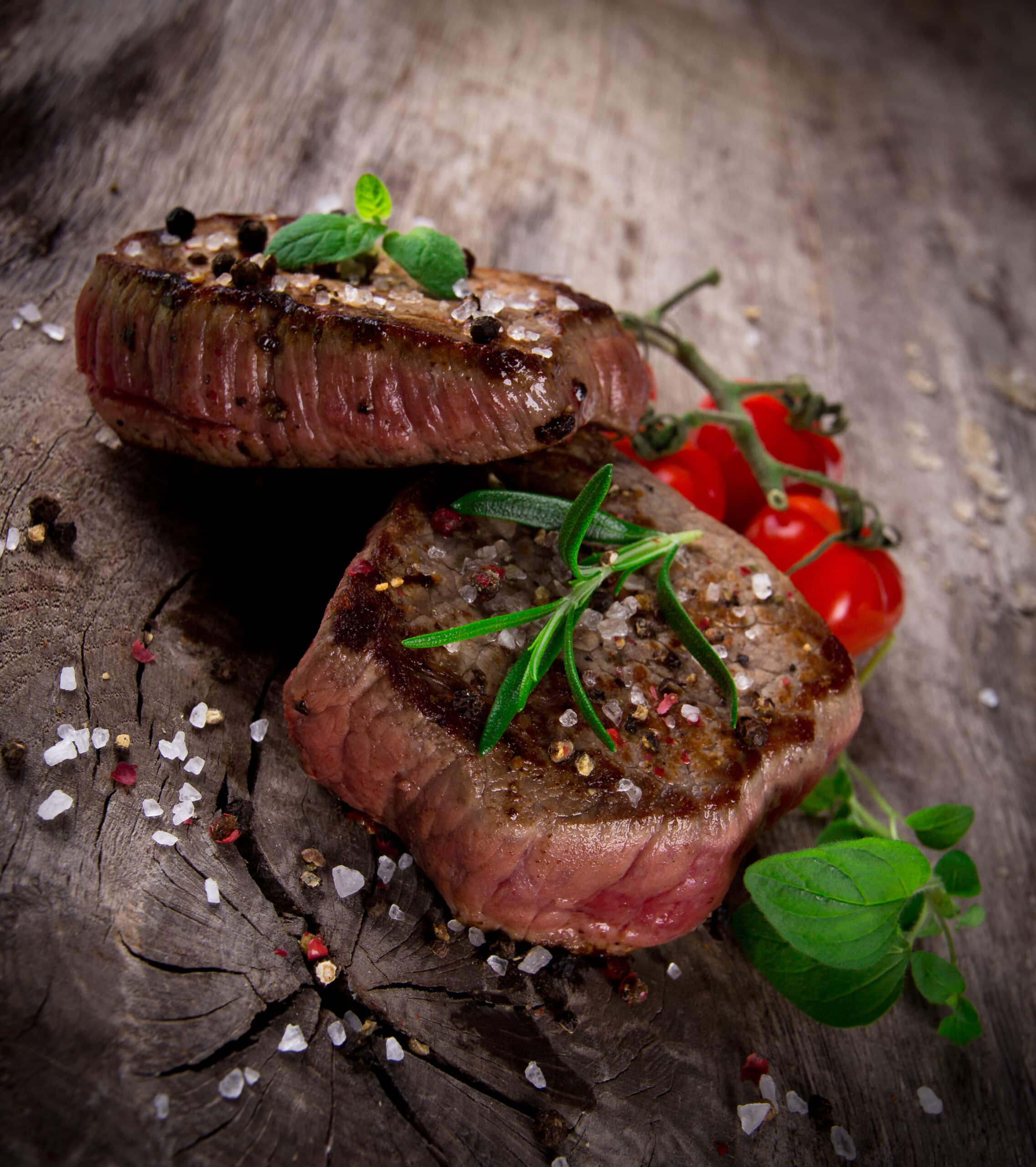 Grilled bbq steaks with fresh herbs and tomatoes