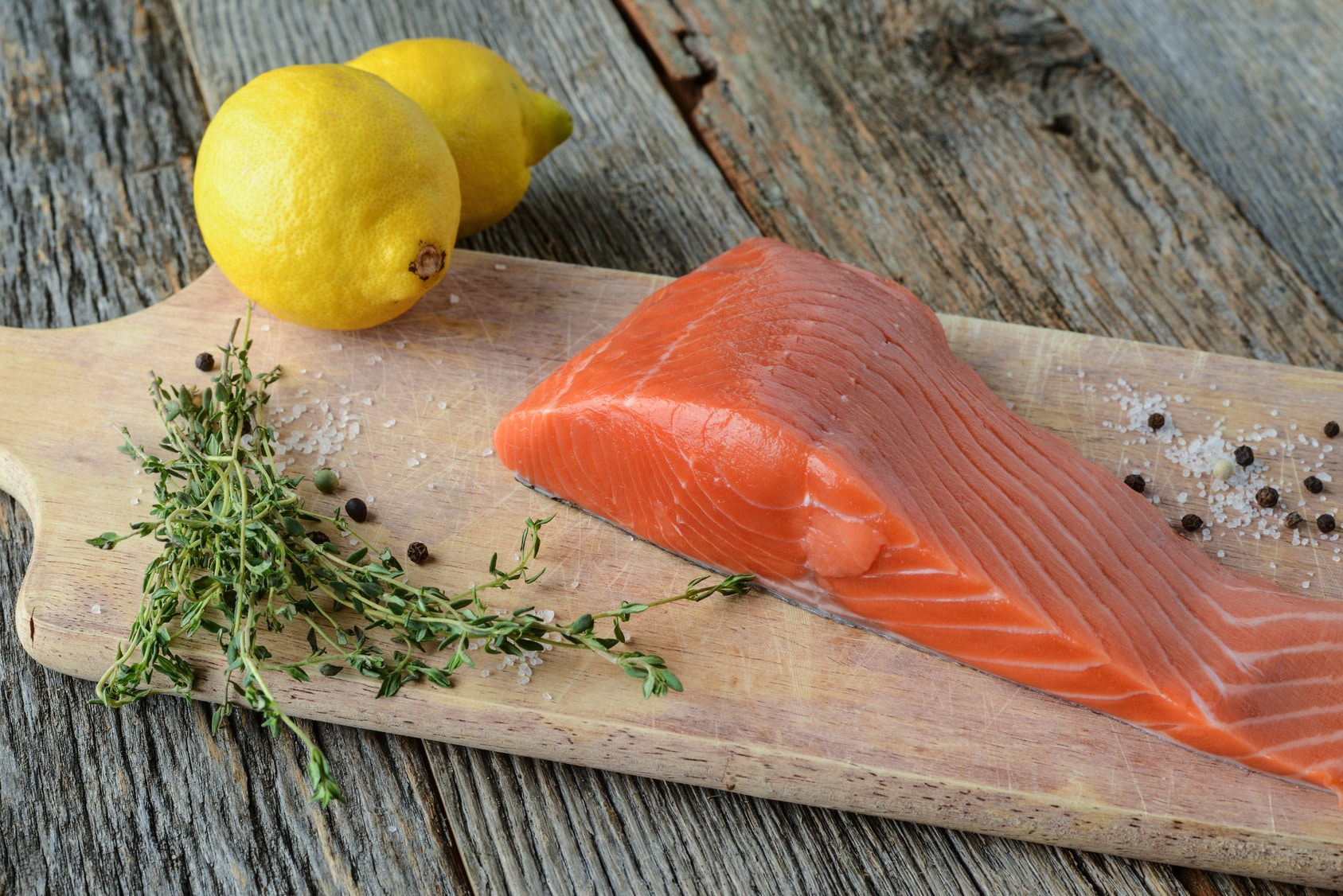 Salmon on a Cutting Board with Lemon, Salt and Pepper